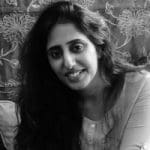Black and white headshot of a woman with long hair.