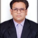 Headshot of a man in a suit and glasses